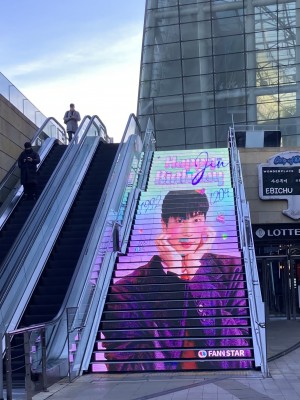 A few blue panels in his face…

Konkuk Star City,
LED Staircase at the Main Plaza