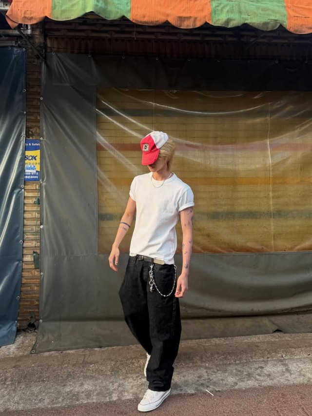 The Eight, wearing a red hat and enjoying a leisurely day... healing while riding a bicycle in an alleyway