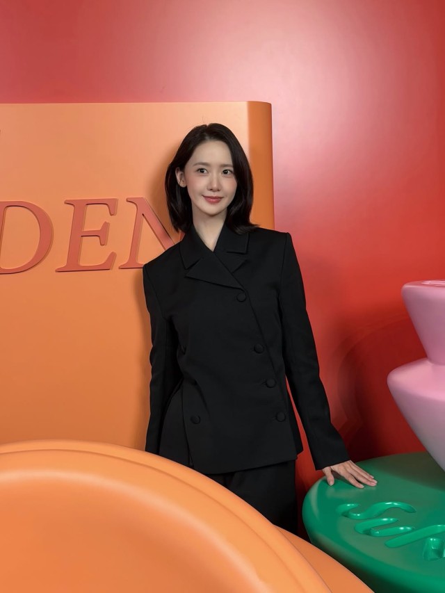 Yoona, displaying elegant grace amidst dazzling floral decorations... 