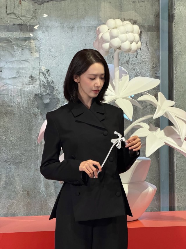 Yoona displaying elegant grace amidst dazzling floral decorations Exploding with sophisticated charm